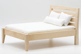 Bed, Unfinished with White Mattress Cover and 3 Pillows.