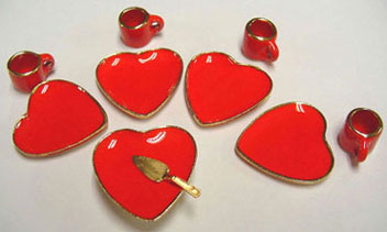 Miniature heart shaped dessert dishes for a dollhouse in red ceramic. 