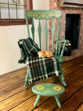 A 1:12 miniature scale hand painted rocking chair with blanket and kitten