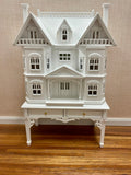 White Victorian Dollhouse for a Dollhouse with matching display table. 