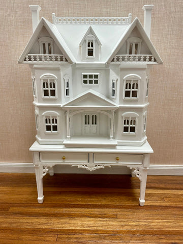 White Victorian Dollhouse for a Dollhouse with matching display table. 