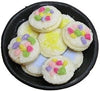 Cookies with Frosting and Sprinkles on a Black Plate