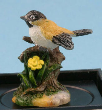 Black capped Chickadee with daffodils statuette by Jeannetta Kendall
