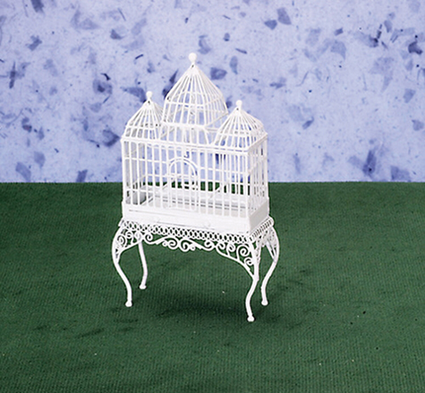 Large three peak white wire bird cage on fancy table