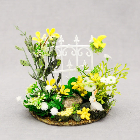Small White Fence with Yellow and White Flowers