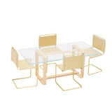 A miniature dining room set with beige suede chairs and a clear glass table, at a 1:12 scale.